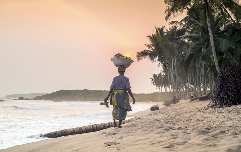 A local woman on the beach at sunset